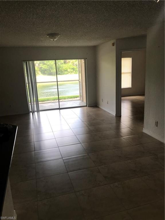 8245 Ibis Club Drive, Unit 409 Naples, FL 34104 - Photo 6 of 18 a view of an empty room with glass door