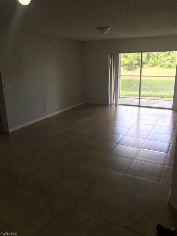 8245 Ibis Club Drive, Unit 409 Naples, FL 34104 - Photo 7 of 18 a view of an empty room with a window