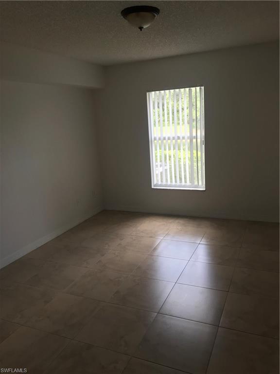 8245 Ibis Club Drive, Unit 409 Naples, FL 34104 - Photo 10 of 18 an empty room with a window