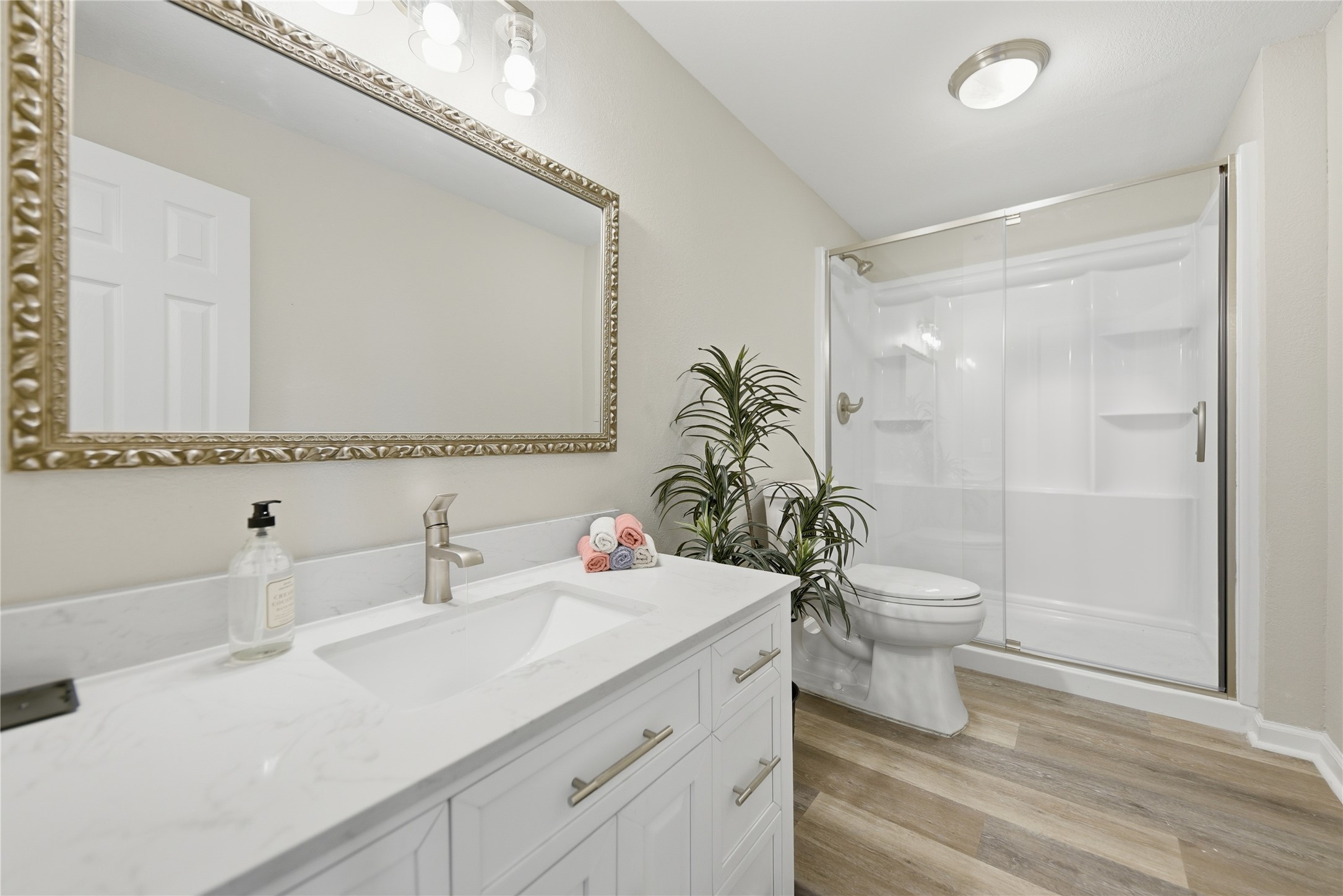 1702 Rampart Street Columbus, TX 78934 - Photo 7 of 38 Full bathroom featuring vanity, a shower stall, and light wood finished floors