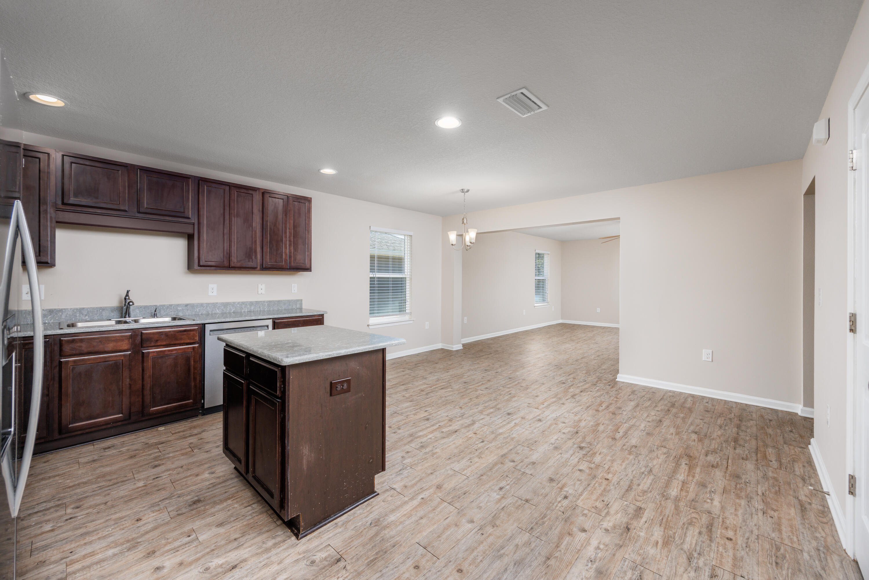 617 Fanny Ann Way Freeport, FL 32439 - Photo 2 of 21 a kitchen with stainless steel appliances granite countertop a stove a sink and a refrigerator
