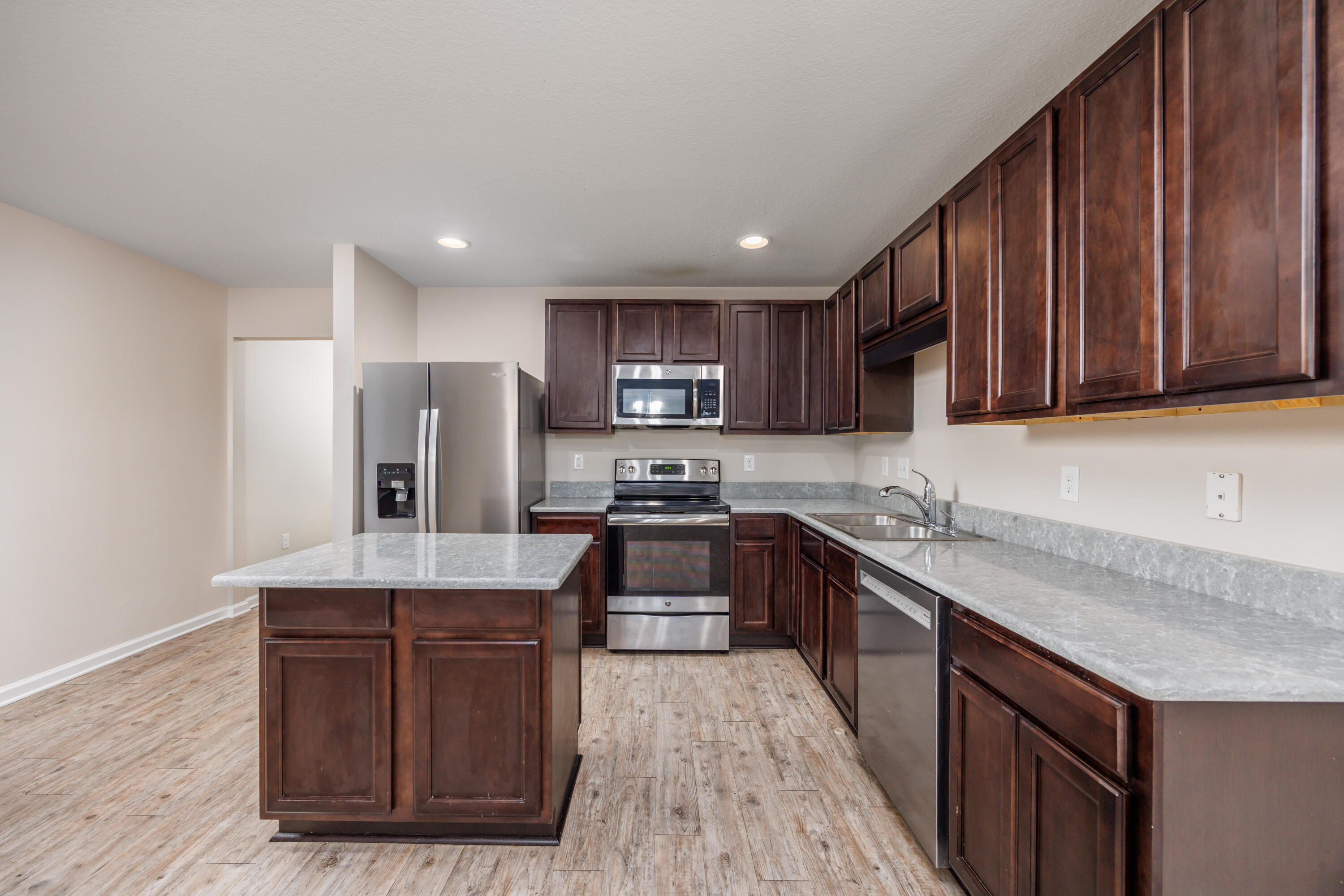 617 Fanny Ann Way Freeport, FL 32439 - Photo 4 of 21 a kitchen with stainless steel appliances granite countertop wooden cabinets a stove top oven a sink and dishwasher