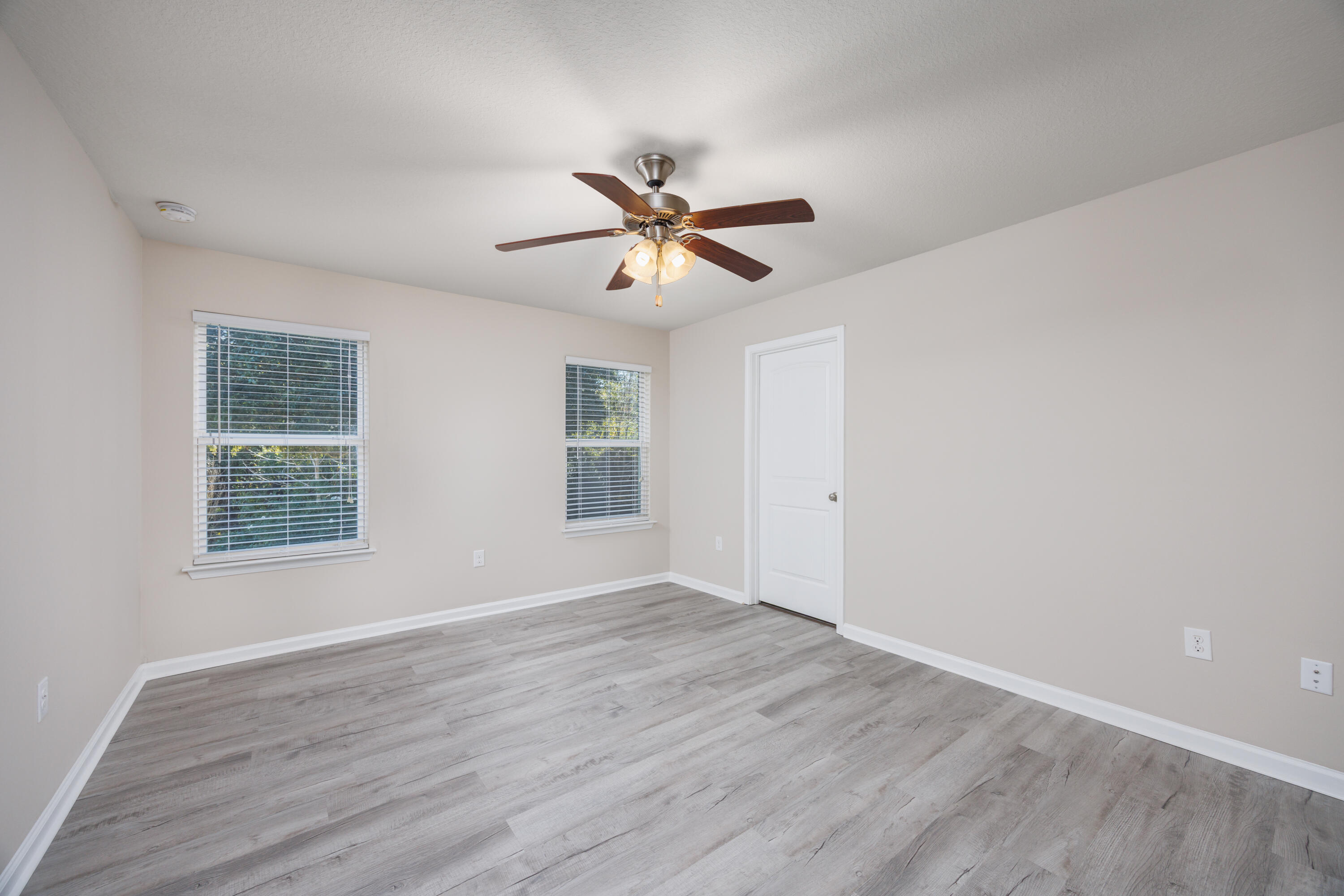 617 Fanny Ann Way Freeport, FL 32439 - Photo 9 of 21 an empty room with wooden floor and windows