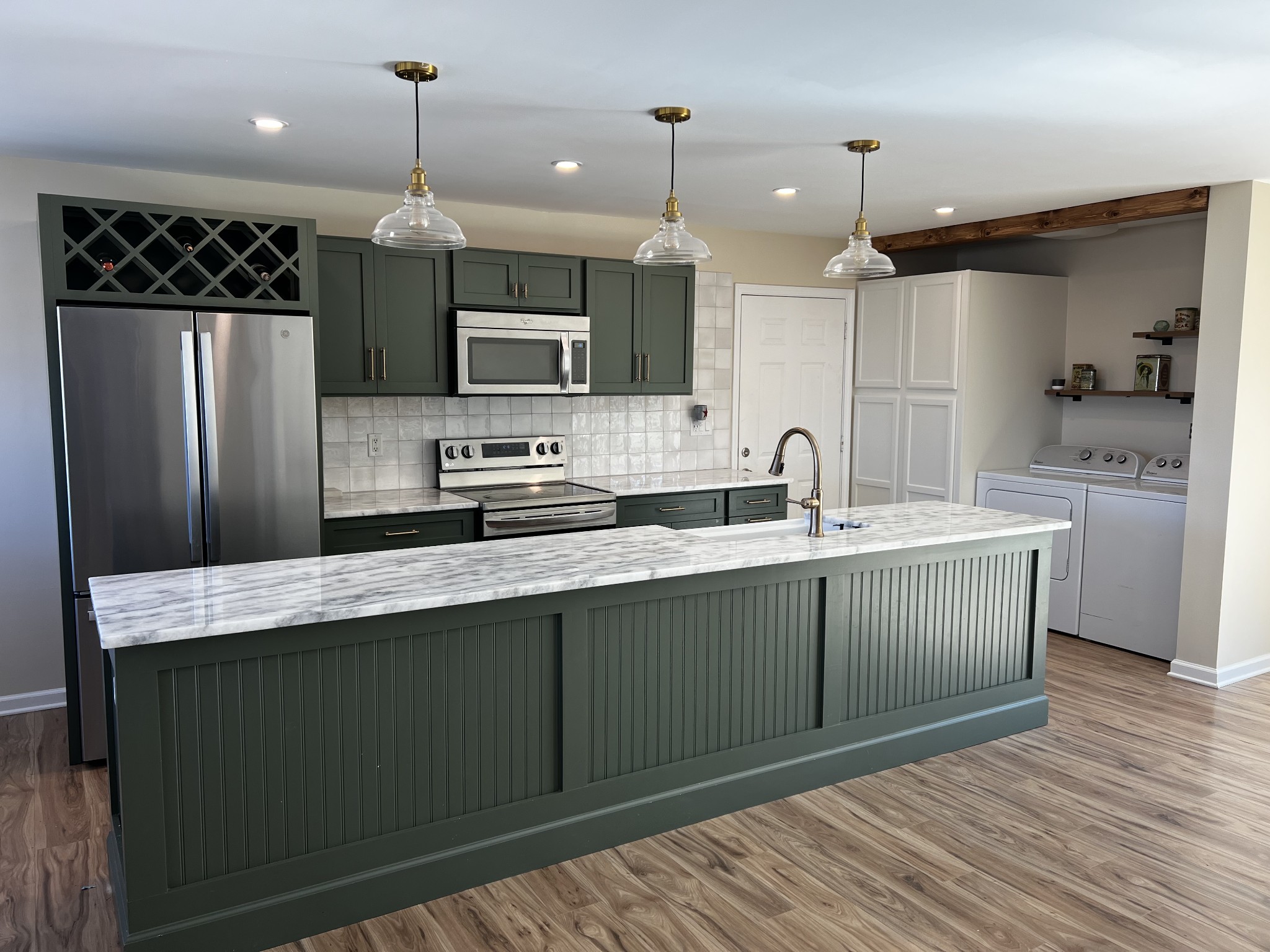 523 D V Circle Spring Hill, TN 37174 - Photo 3 of 10 a kitchen with stainless steel appliances kitchen island a sink refrigerator and microwave