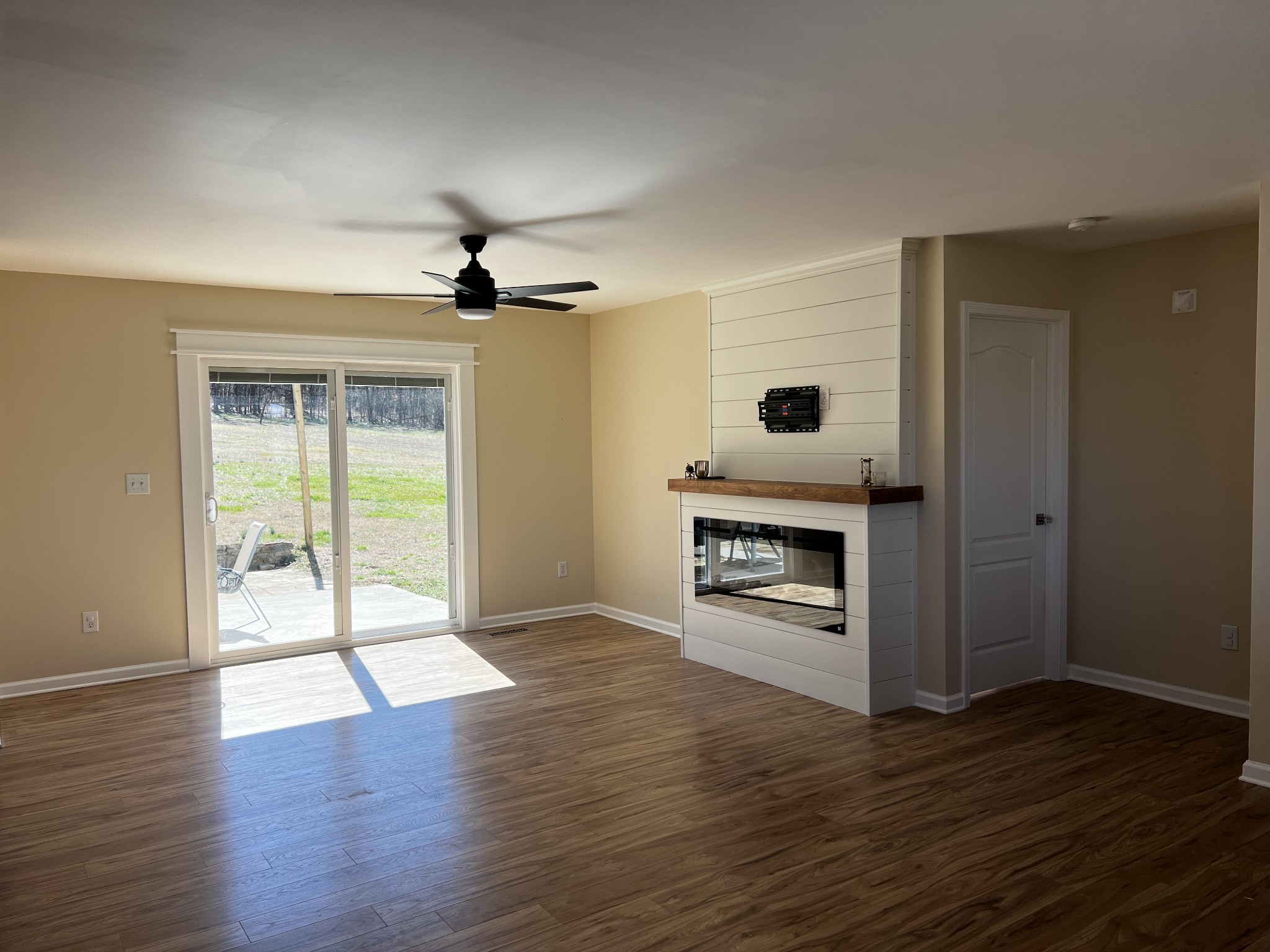 523 D V Circle Spring Hill, TN 37174 - Photo 4 of 10 a view of an empty room with a fireplace and wooden floor
