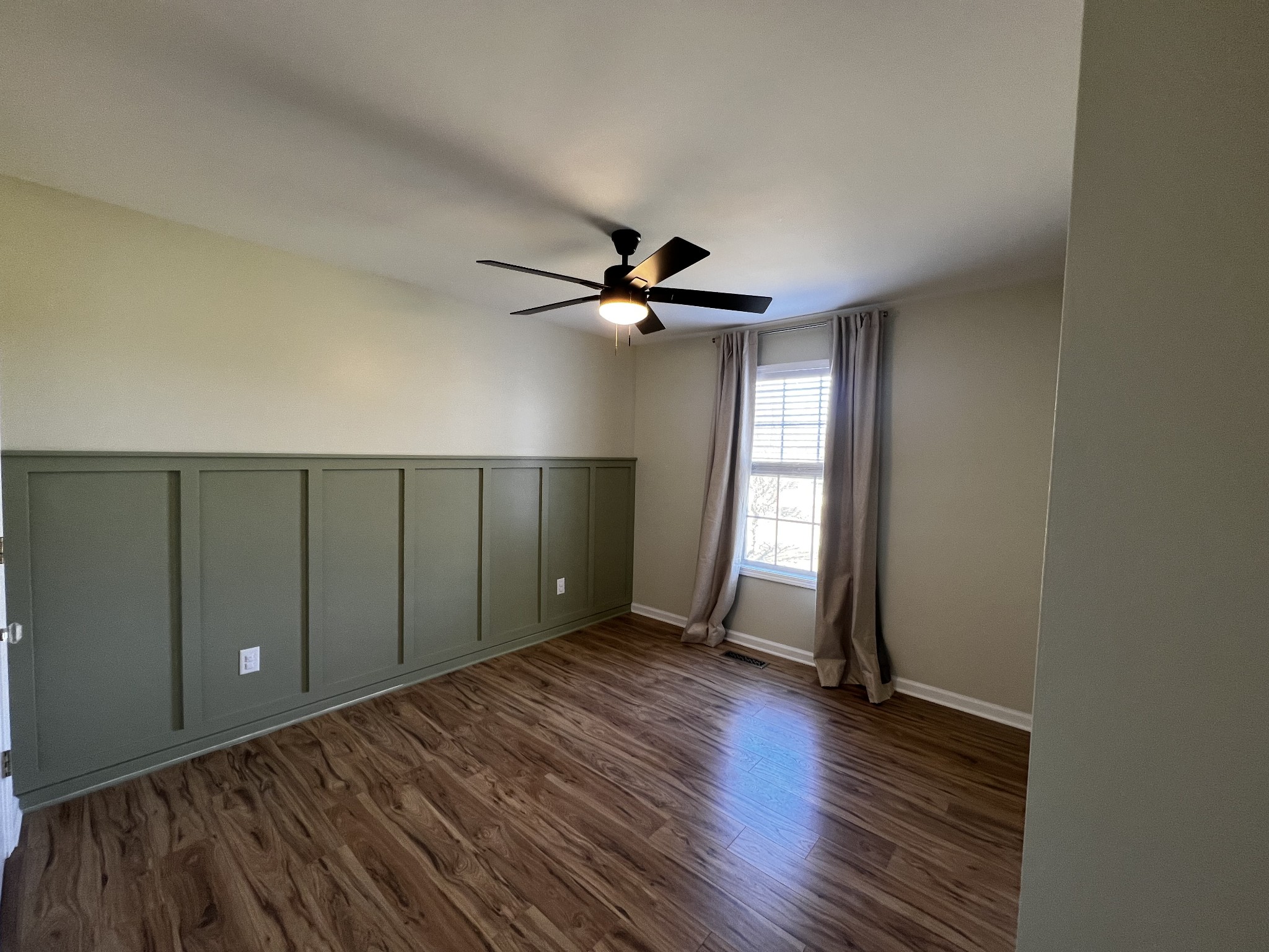 523 D V Circle Spring Hill, TN 37174 - Photo 8 of 10 a view of an empty room with wooden floor and a window