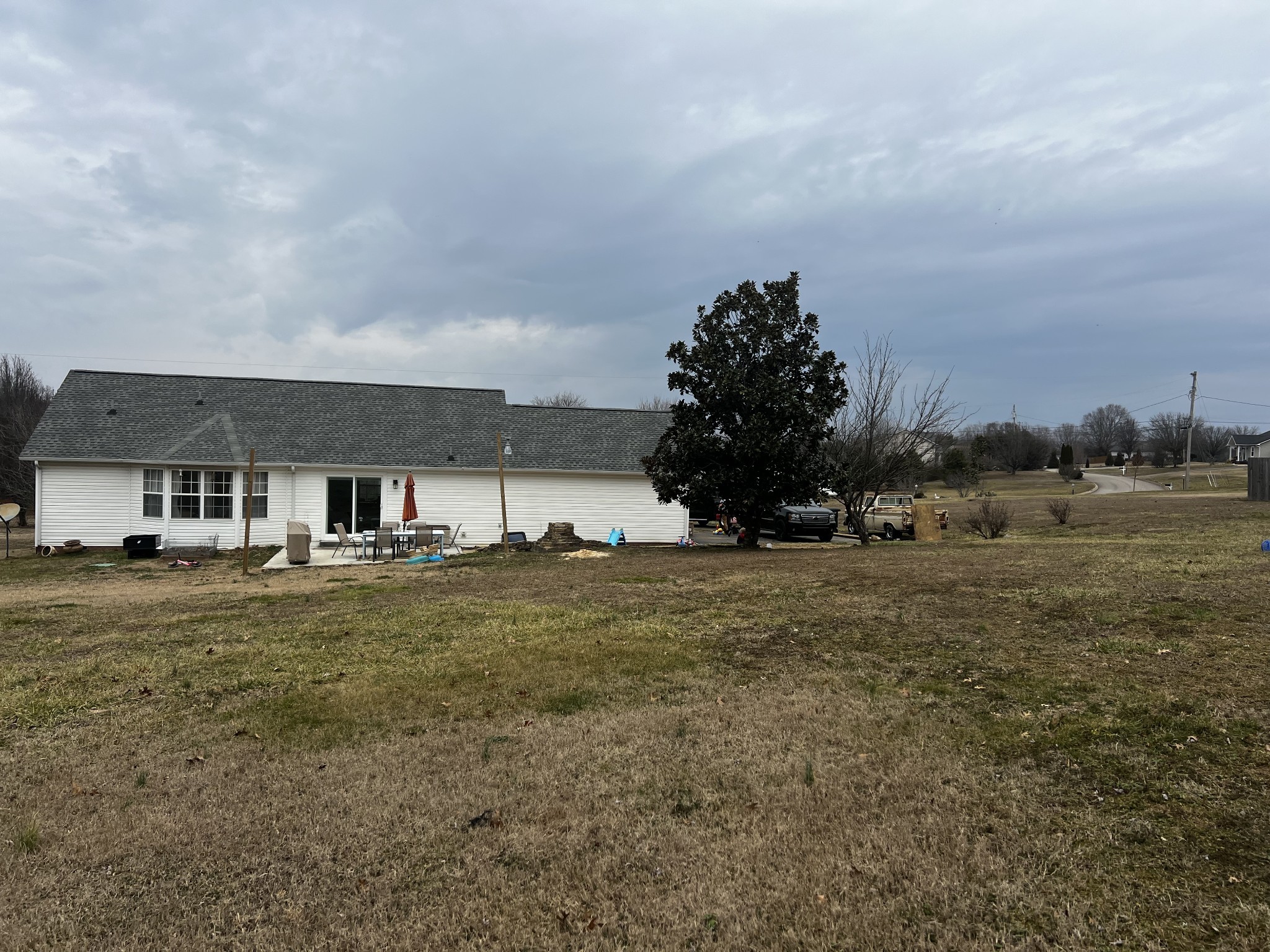 523 D V Circle Spring Hill, TN 37174 - Photo 9 of 10 a view of a big house with a big yard and large trees