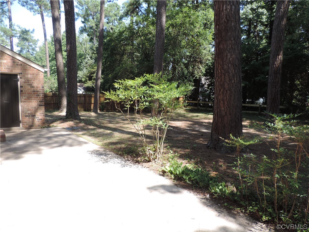 10616 Savoy Road North Chesterfield, VA 23235 - Photo 28 of 29 a wooden bench sitting in the middle of a forest