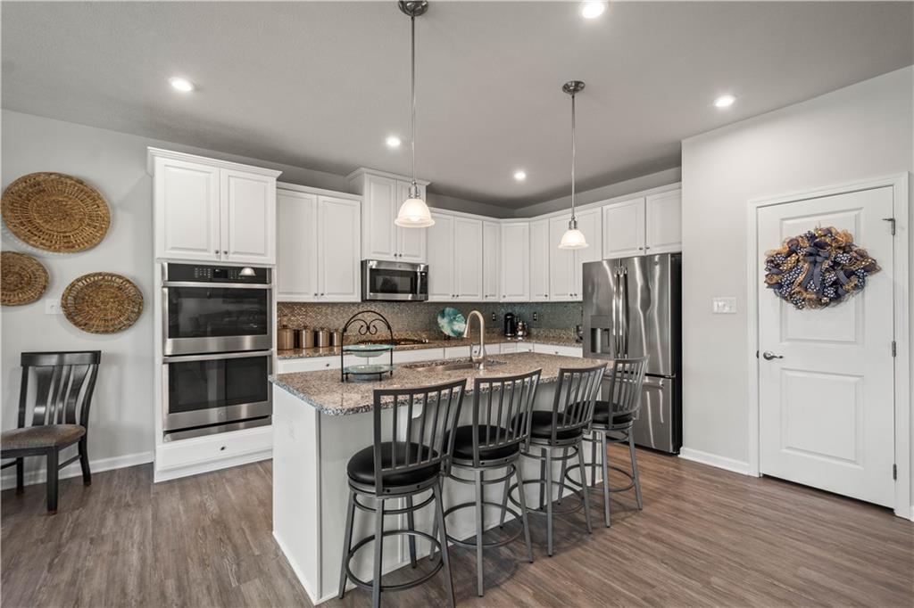 107 High Pointe Drive Washington, PA 15301 - Photo 13 of 38 a kitchen with stainless steel appliances a dining table chairs stove and refrigerator