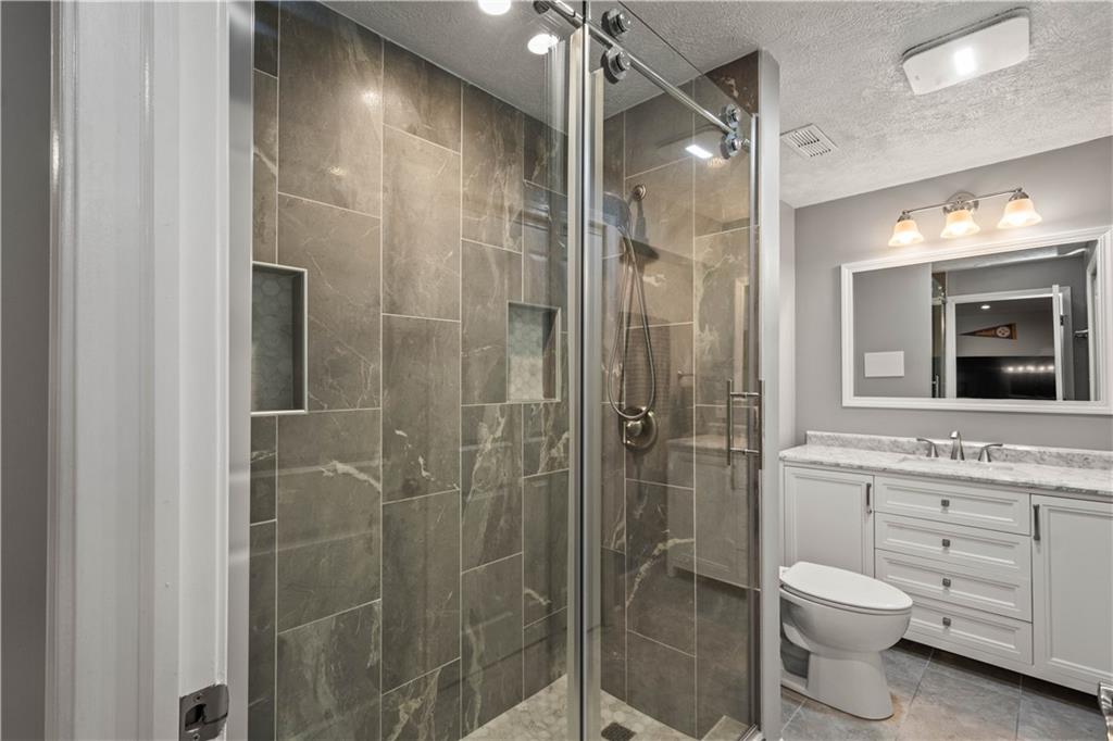 107 High Pointe Drive Washington, PA 15301 - Photo 29 of 38 a bathroom with a toilet a sink and shower