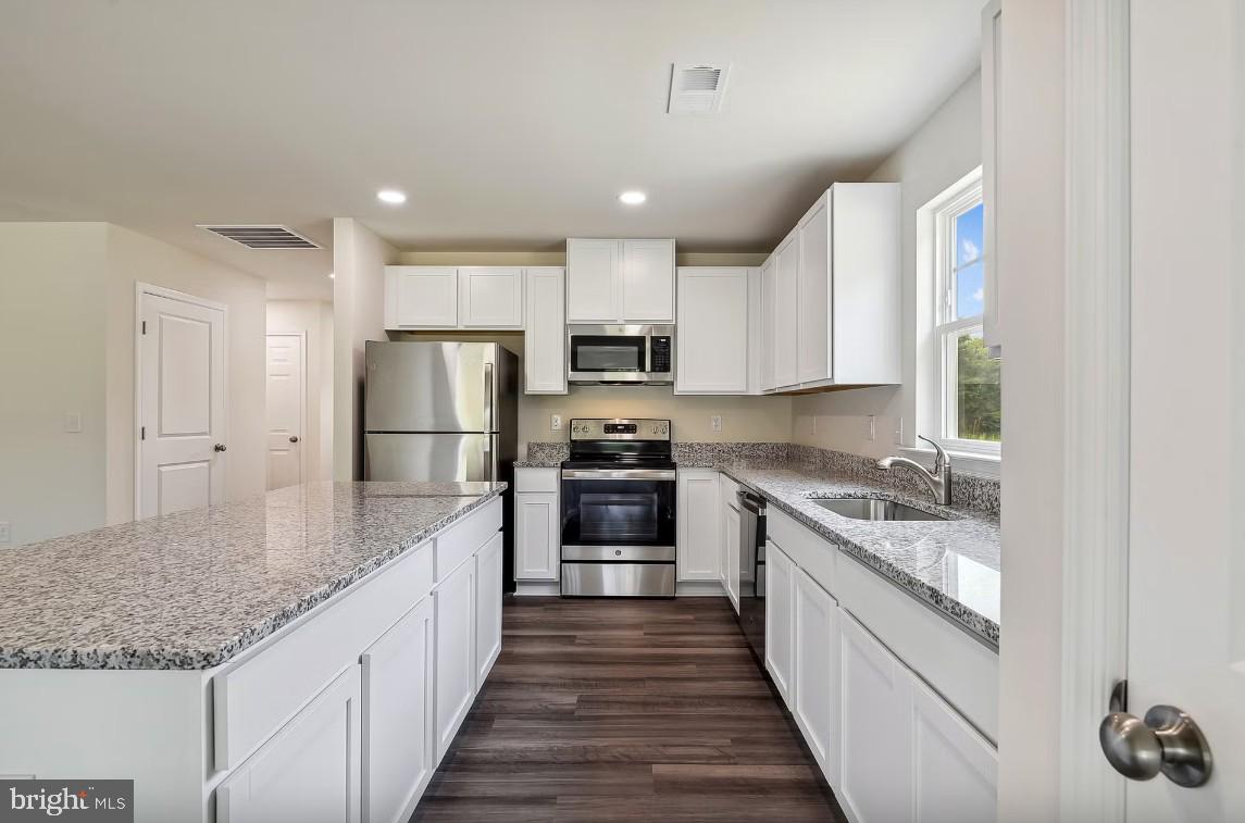 1 Pepperbox Road Laurel, DE 19956 - Photo 2 of 16 a large kitchen with stainless steel appliances granite countertop a large counter top and a stove top oven