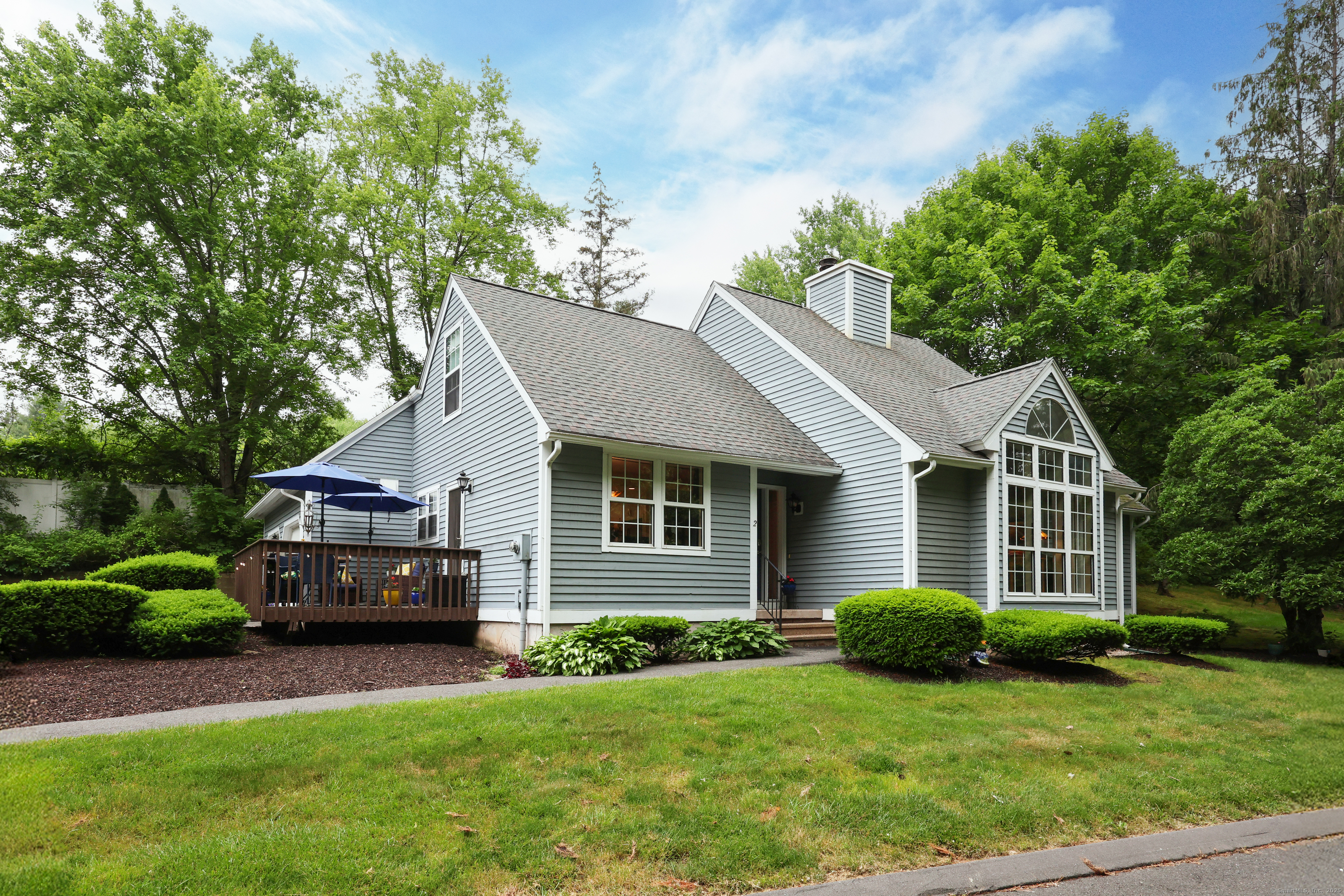 2 Windcrest Drive, Unit 2 Granby, CT 06035 - Photo 1 of 1 a front view of a house with a yard