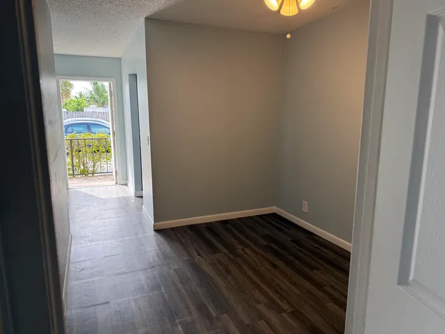 a view of an empty room and a window