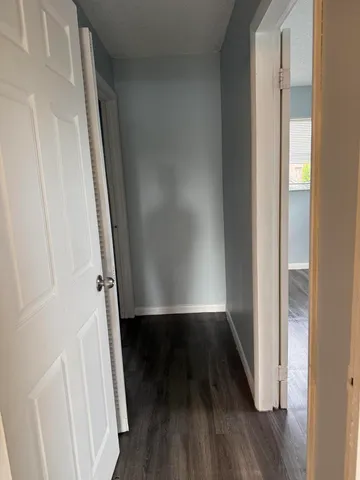 a view of a small space with wooden floor and a window