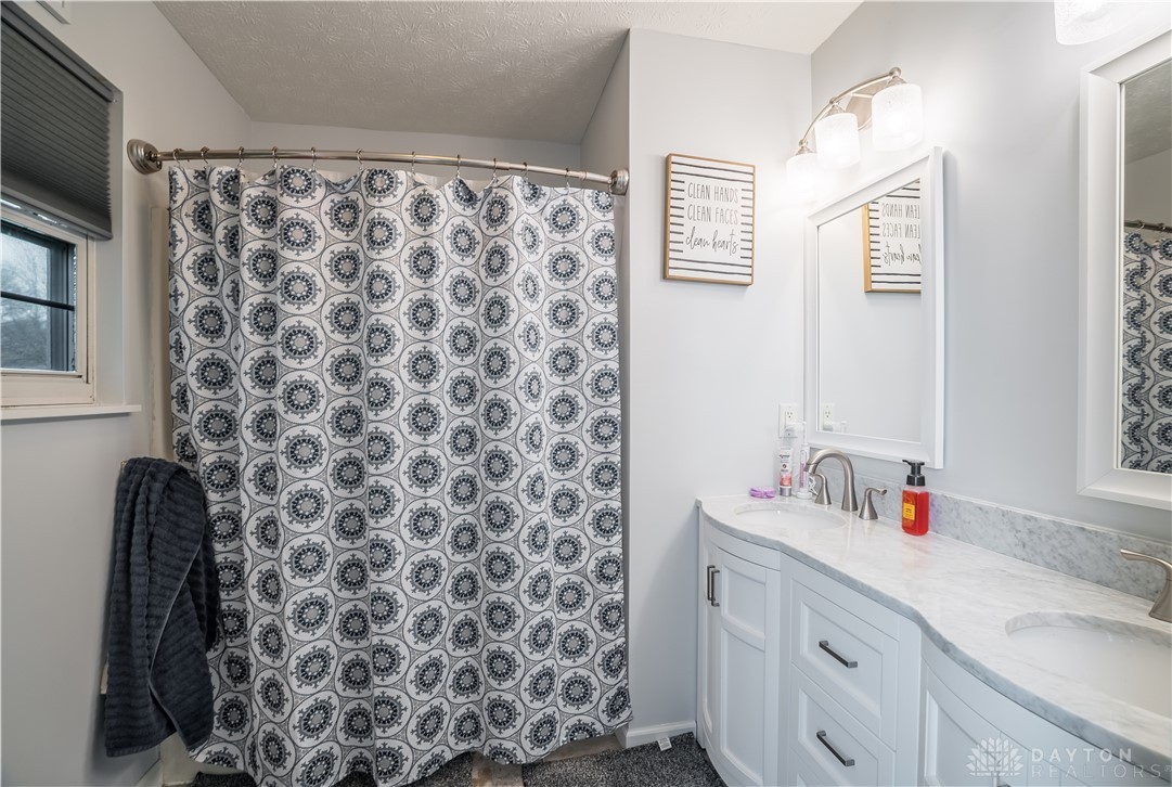 1442 Langdon Road Sidney, OH 45365 - Photo 17 of 34 This bathroom features a sleek vanity with ample counter space and a modern shower area.