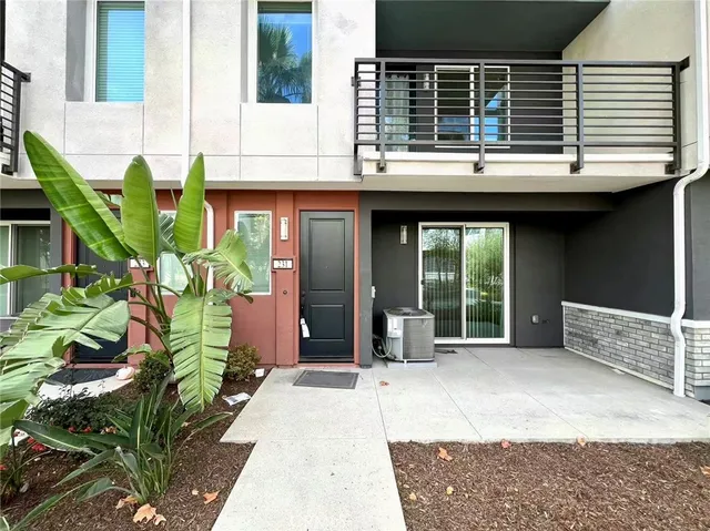 a house with potted plants in front of door
