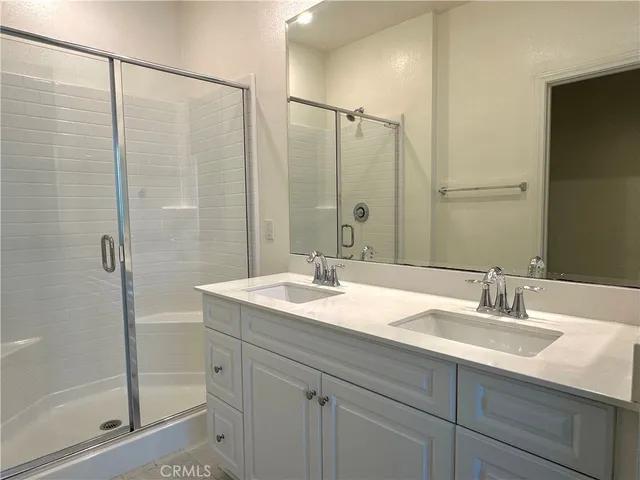 a bathroom with a double vanity sink and mirror