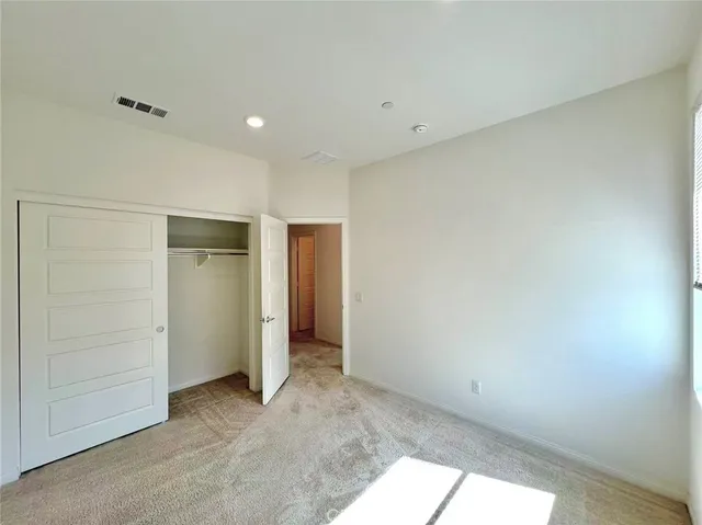 an empty room with closet area