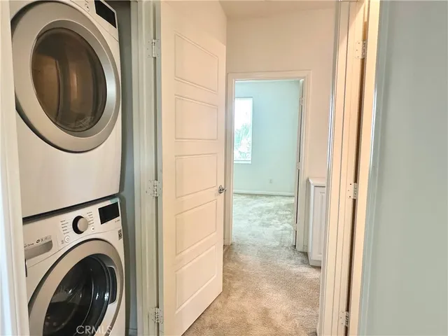 a view of a hallway with washer and dryer