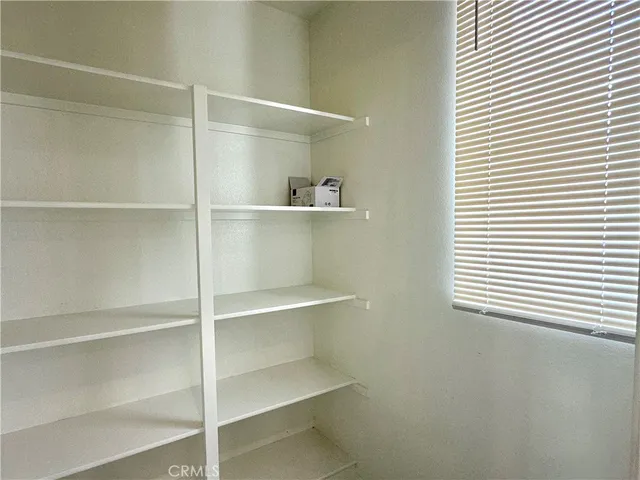 a view of an empty room with shelves