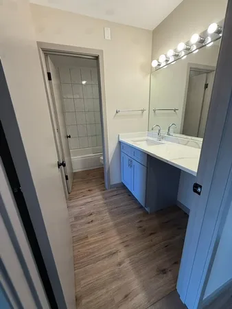 a bathroom with a sink vanity and a mirror