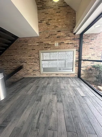 a view of empty room with wooden floor and fireplace