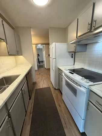 a kitchen with a refrigerator stove and sink