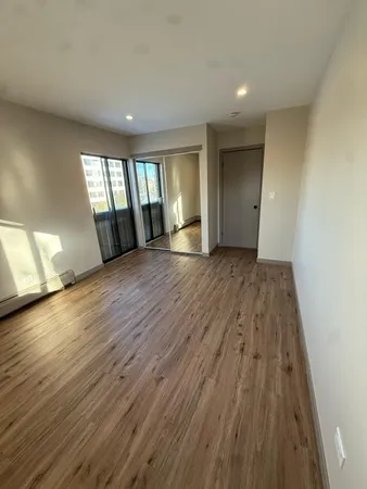 wooden floor in an empty room with a window