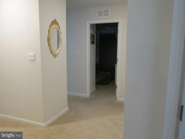 a view of a bathroom with a shower and mirror