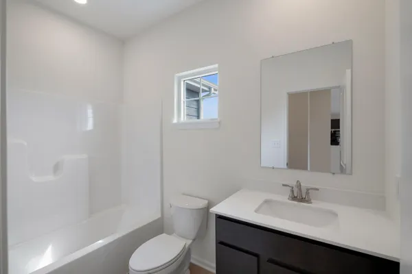 a bathroom with a sink toilet and vanity