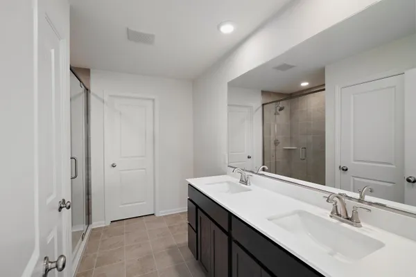 a bathroom with a sink double vanity and a mirror