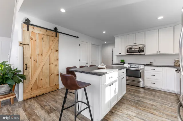 a living room with furniture and kitchen view