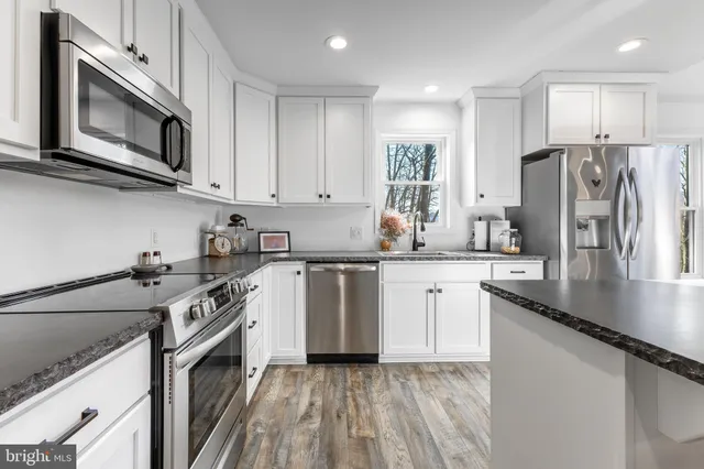 a view of a room with furniture and wooden floor