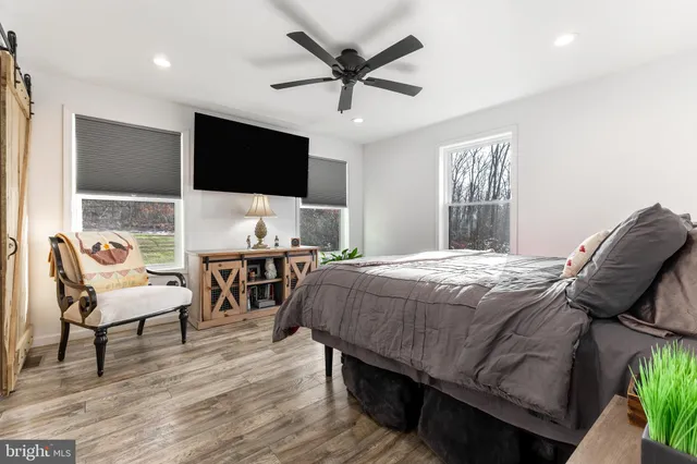 a view of a house with a yard chairs and iron fence