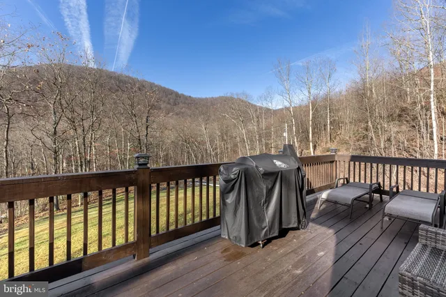 a kitchen with a white stove top oven and white cabinets with wooden floor