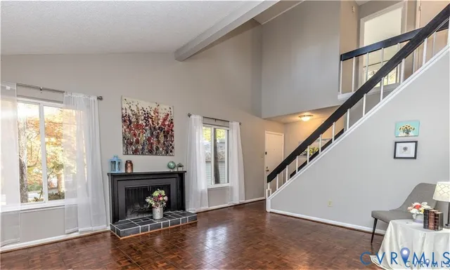a view of a livingroom with furniture staircase and a fireplace