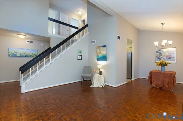 a view of an empty room and stairs