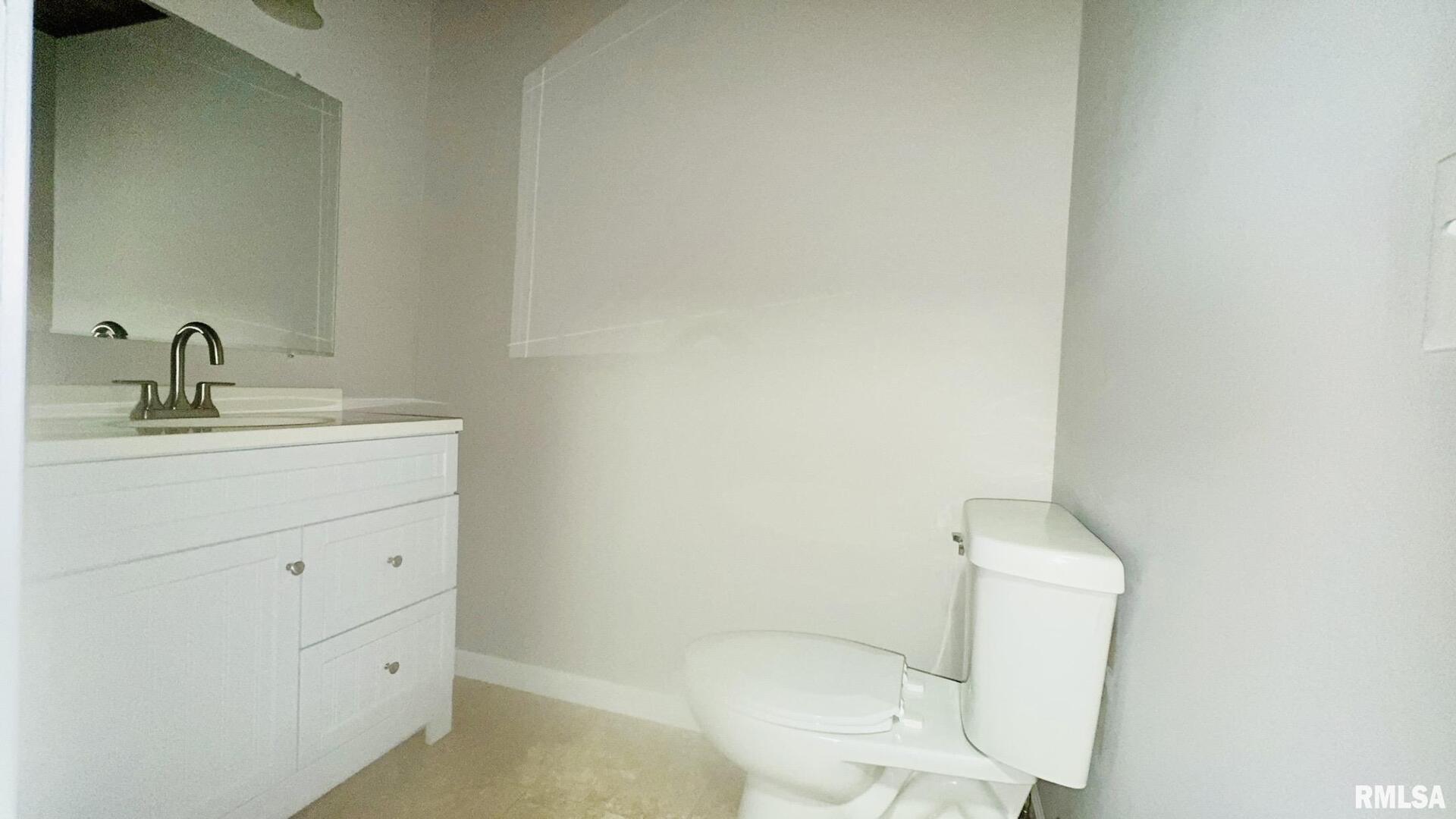 1206 South Main Street Benton, IL 62812 - Photo 20 of 23 a bathroom with a toilet sink vanity and mirror