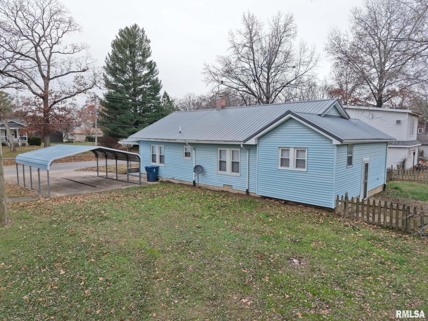 1206 South Main Street Benton, IL 62812 - Photo 6 of 23 a view of a house with a yard and large trees
