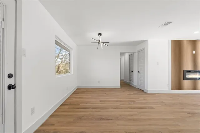 a view of a room with wooden floor and window