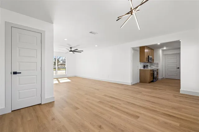 wooden floor in an empty room and a kitchen