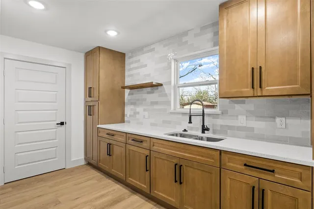 a kitchen with a sink and cabinets