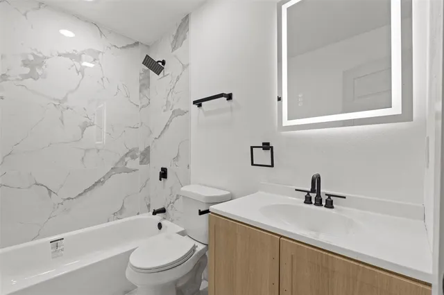 a bathroom with a sink a toilet and a bathtub