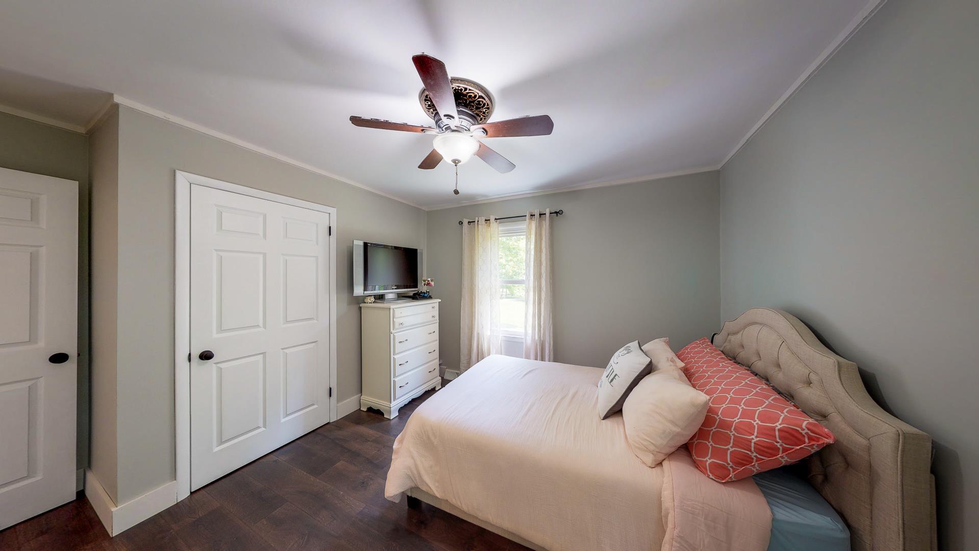 2361 Joe Brown Road Spring Hill, TN 37174 - Photo 17 of 27 a bedroom with a bed and a chandelier