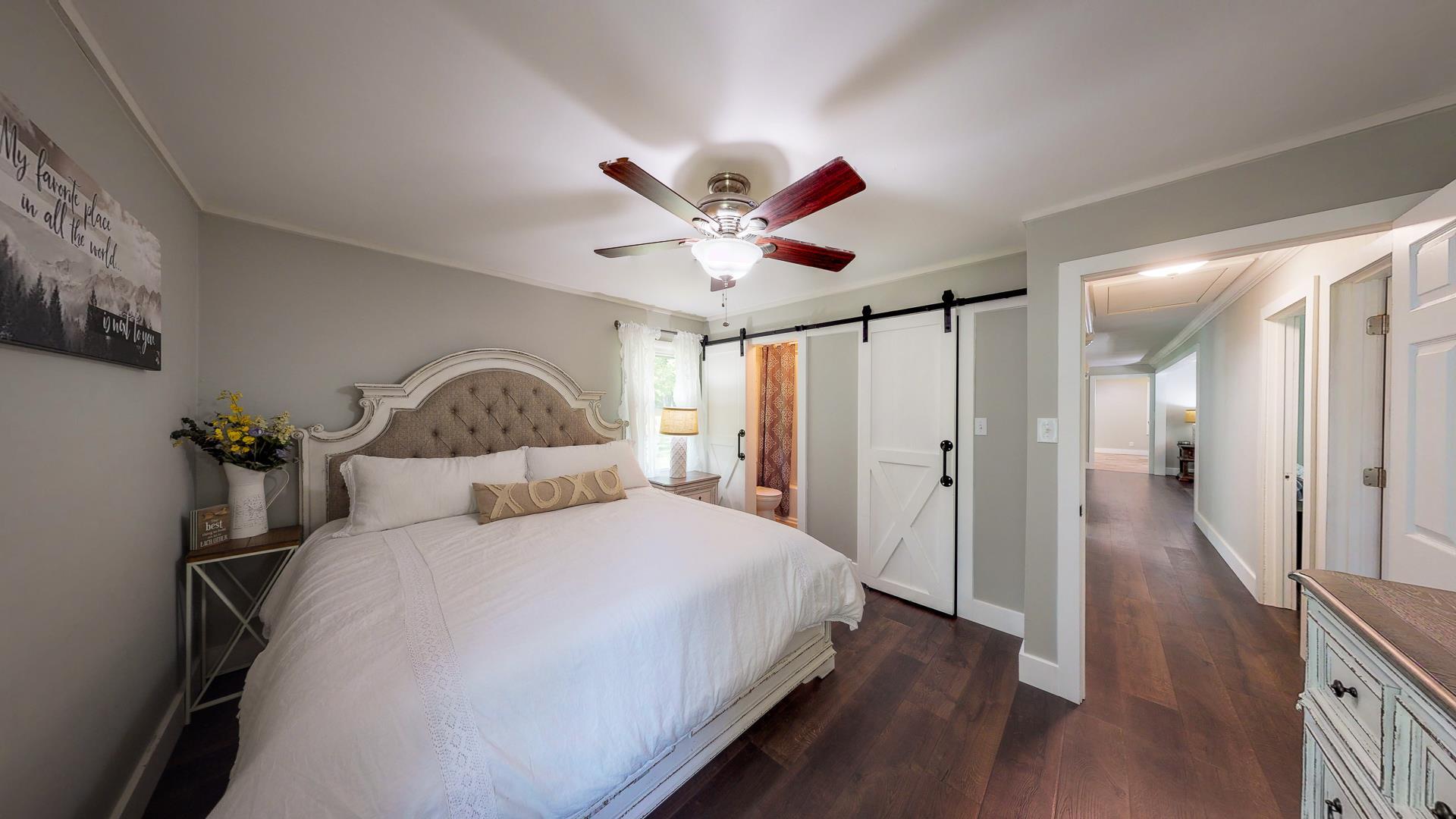2361 Joe Brown Road Spring Hill, TN 37174 - Photo 19 of 27 a spacious bedroom with a bed and a ceiling fan