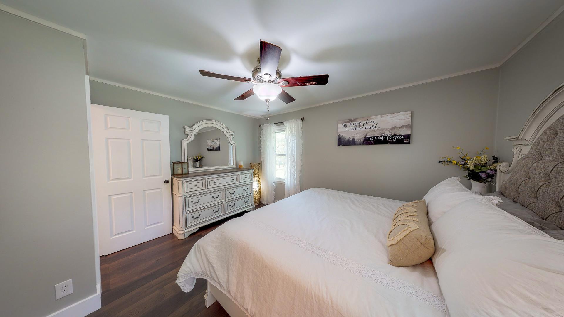2361 Joe Brown Road Spring Hill, TN 37174 - Photo 20 of 27 a bedroom with a bed and a chandelier