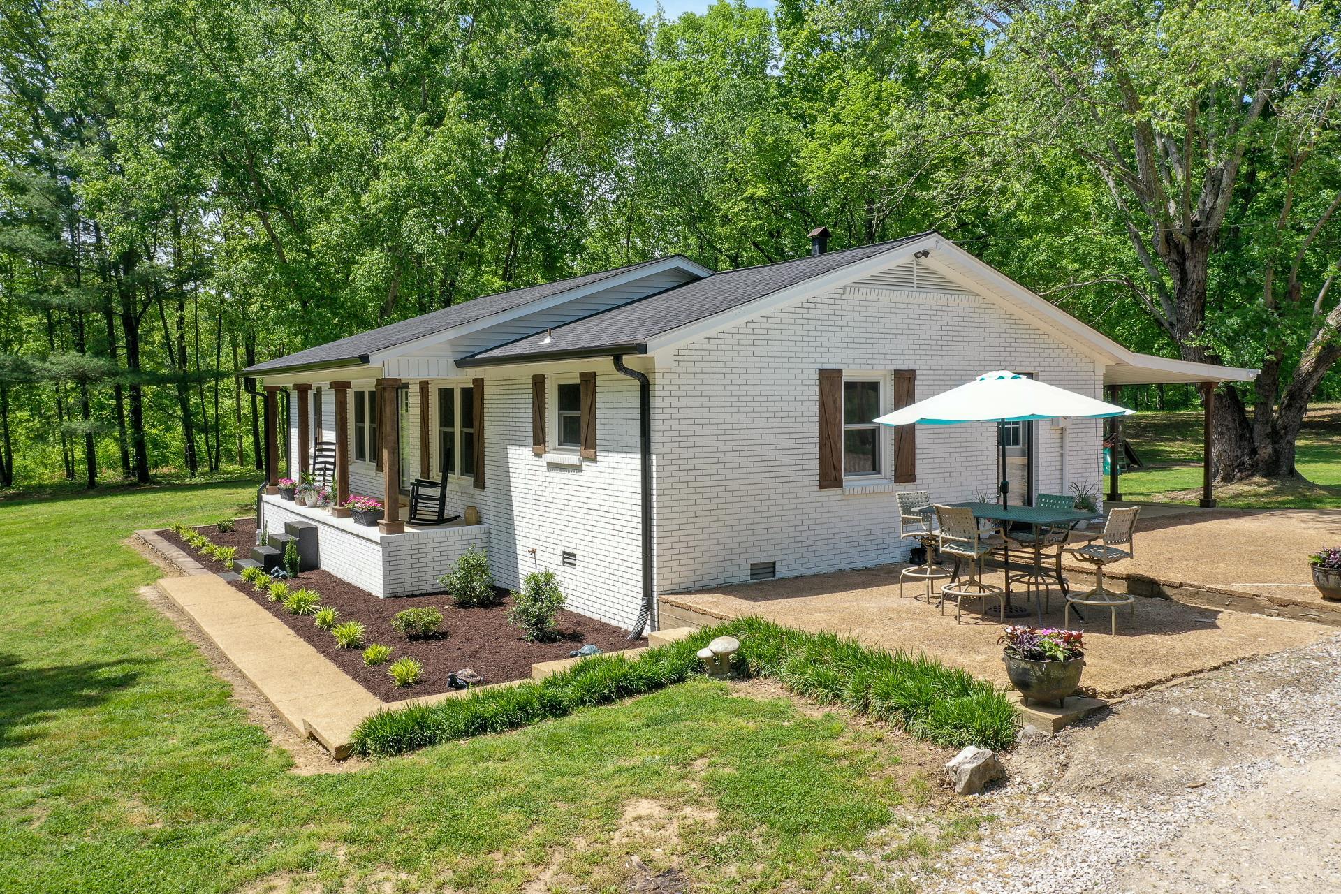 2361 Joe Brown Road Spring Hill, TN 37174 - Photo 3 of 27 a view of a house with backyard sitting area and garden