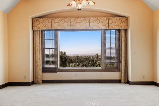 a view of a room with a fireplace and a window