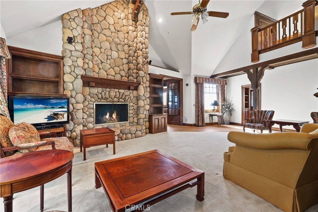 7008 Hawarden Drive Riverside, CA 92506 - Photo 22 of 37 a living room with furniture a table and a fireplace