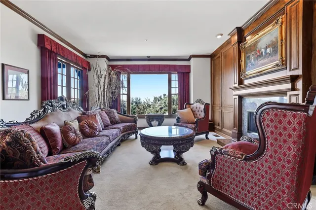 a living room with furniture fireplace and a large window